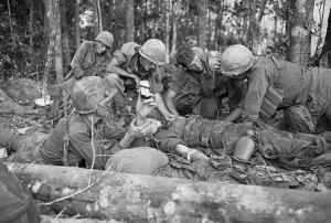 Original Caption: Emergency Transfusion. Dak To, South Vietnam: During a bloody battle, when a soldier is wounded and needs a transfusion, it takes place there on the spot, in the battle zone. Here, a G.I. gets a transfusion near infamous Hill 875, captured by American forces after some of the most violent fighting of the war in Vietnam. North Vietnamese troops poured heavy mortar fire on an artillery base near Dak To and the Special Forces camp in Kontum, 40 miles to the South.